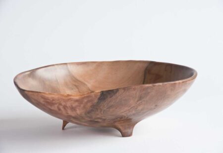 Pohutukawa bowl with three feet and organic surface texture from natural warping.