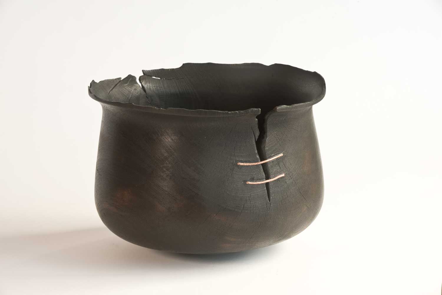 Wooden-Artefact-BB10-c Burnt wooden vessel with cracked rim, repaired with hand-beaten copper wire